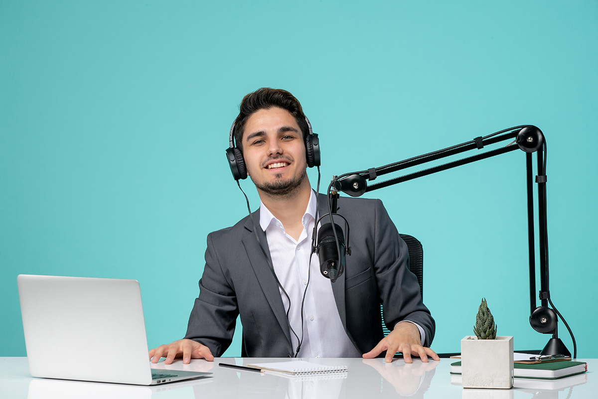 blogger journalist young cute handsome guy in grey suit recording video proud